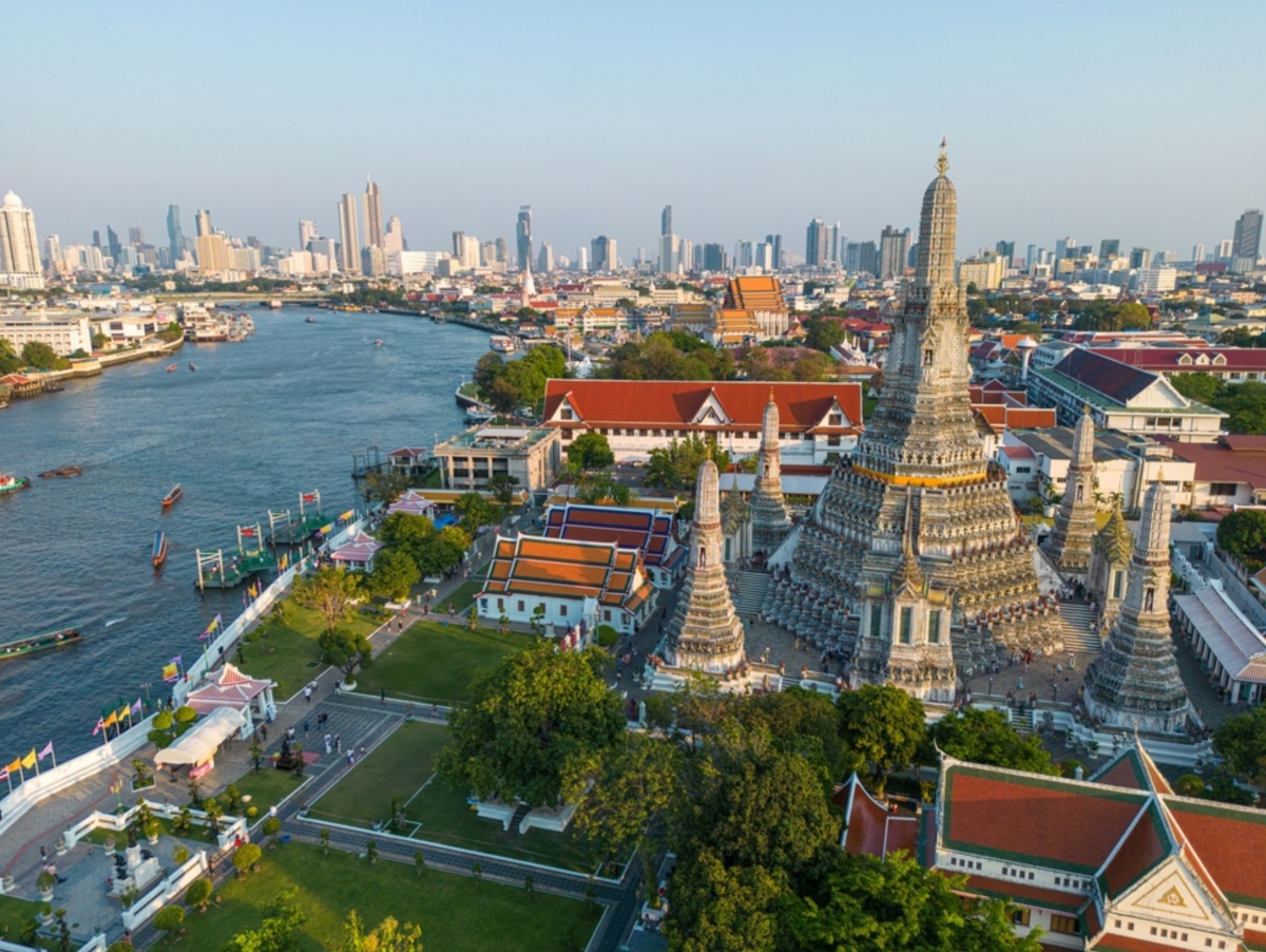 Wat Arun and the Chao Phraya river with the Bangkok skyline beyond
